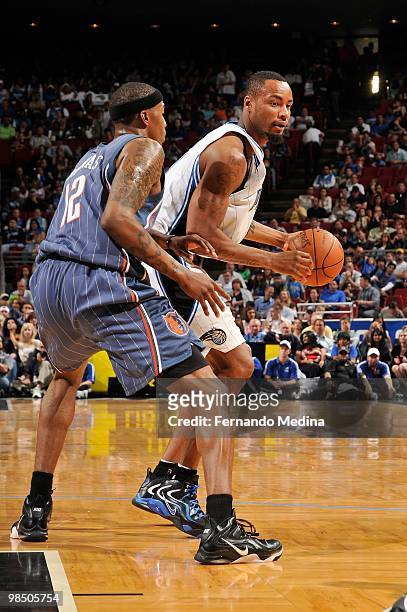Rashard Lewis of the Orlando Magic moves the ball against Tyrus Thomas of the Charlotte Bobcats during the game on March 14, 2010 at Amway Arena in...
