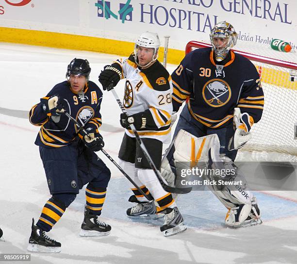 Derek Roy and Ryan Miller of the Buffalo Sabres defend against Mark Recchi of the Boston Bruins in Game One of the Eastern Conference Quarterfinals...