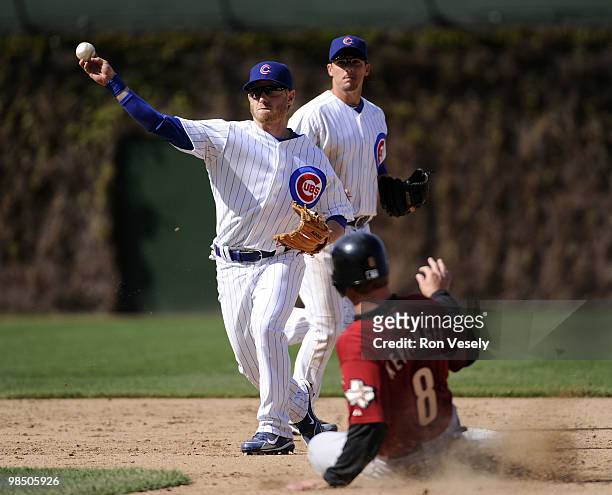 Mike Fontenot of the Chicago Cubs turns a double play over the sliding Jeff Keppinger of the Houston Astros on April 16, 2010 at Wrigley Field in...
