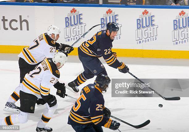 Adam Mair and Michael Grier of the Buffalo Sabres skate ahead of Steve Begin and Shawn Thornton of the Boston Bruins in Game One of the Eastern...