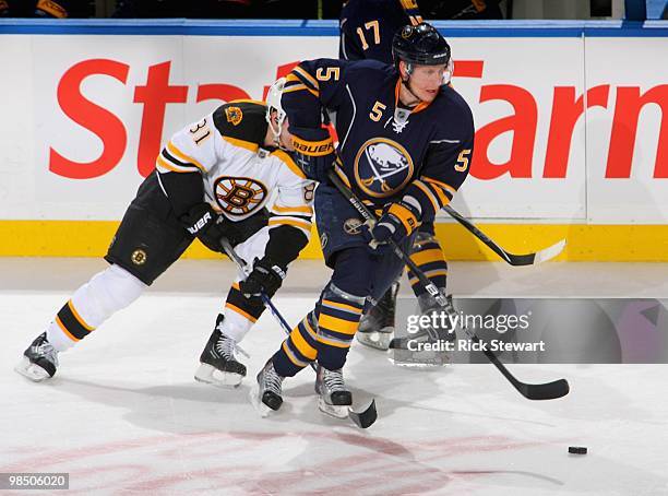 Toni Lydman of the Buffalo Sabres skates ahead of Miroslav Satan of the Boston Bruins in Game One of the Eastern Conference Quarterfinals during the...