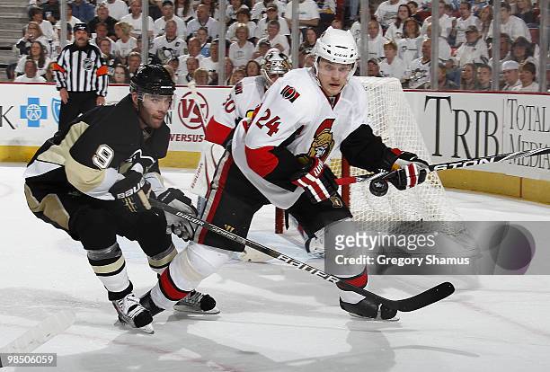 Pascal Dupuis of the Pittsburgh Penguins battles for position against Anton Volchenkov of the Ottawa Senators in Game Two of the Eastern Conference...