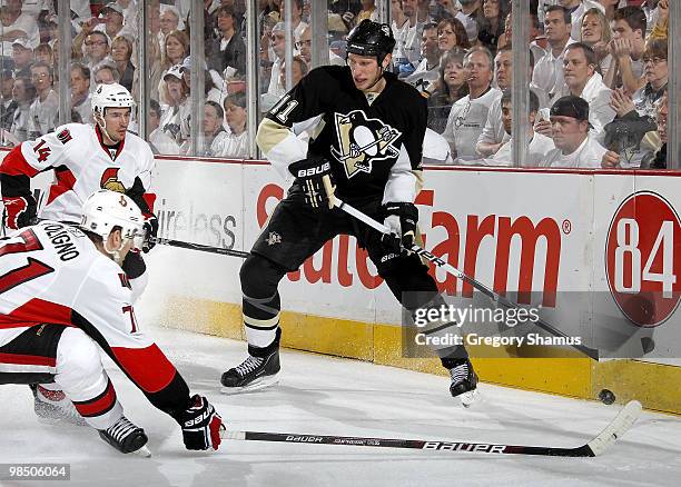 Jordan Staal of the Pittsburgh Penguins looks to pass between the defense of Nick Foligno and Chris Campoli of the Ottawa Senators in Game Two of the...