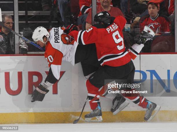 Chris Pronger of the Philadelphia Flyers is hit into the boards by Zach Parise of the New Jersey Devils in Game Two of the Eastern Conference...