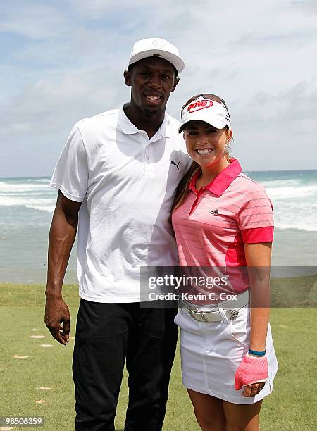 Usain Bolt and Paula Creamer of the United States pose for a photo during the semifinal matches of The Mojo 6 Jamaica LPGA Invitational at Cinnamon...