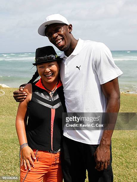 Usain Bolt and Christina Kim of the United States pose for a photo during the semifinal matches of The Mojo 6 Jamaica LPGA Invitational at Cinnamon...
