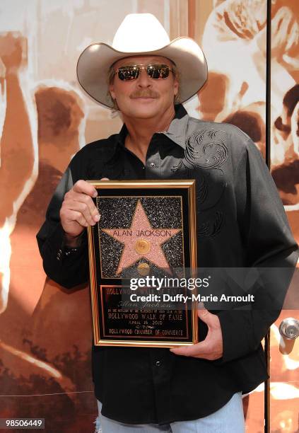 Country singer Alan Jackson poses with his star on the Hollywood Walk Of Fame on April 16, 2010 in Hollywood, California.