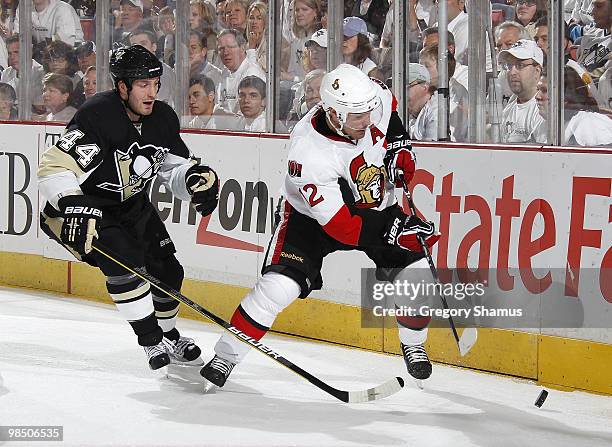 Mike Fisher of the Ottawa Senators reaches for the puck in front of Brooks Orpik of the Pittsburgh Penguins in Game Two of the Eastern Conference...