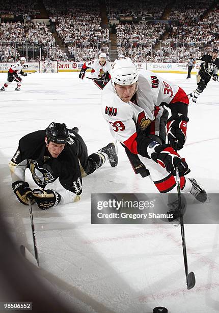 Matt Carkner of the Ottawa Senators reaches for the puck in front of Jordan Staal of the Pittsburgh Penguins in Game Two of the Eastern Conference...