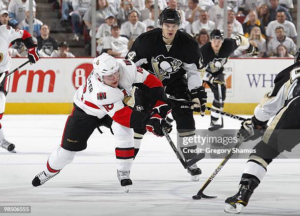 Jesse Winchester of the Ottawa Senators moves the puck in front of Chris Kunitz of the Pittsburgh Penguins in Game Two of the Eastern Conference...