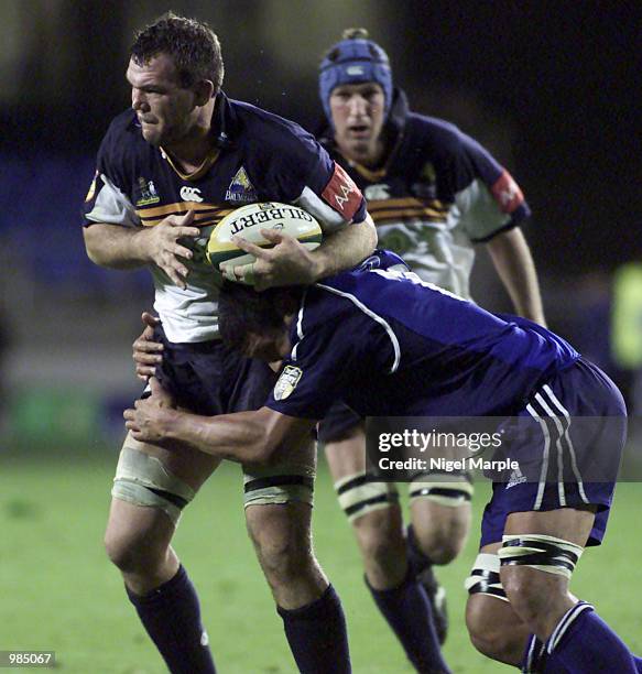 Owen Finegan of the Brumbies is tackled by Ron Cribb of the Blues during the Week 11 Super 12 match between the Blues and the Brumbies at Eden Park,...