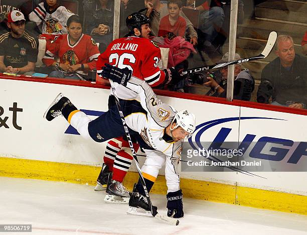 Dave Bolland of the Chicago Blackhawks and Dan Hamhuis of the Nashville Predators collide along the boards in Game One of the Western Conference...