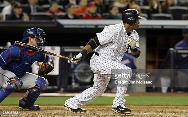 Robinson Cano of the New York Yankees follows through on a fourth inning infield single against the Texas Rangers on April 16, 2010 at Yankee Stadium...
