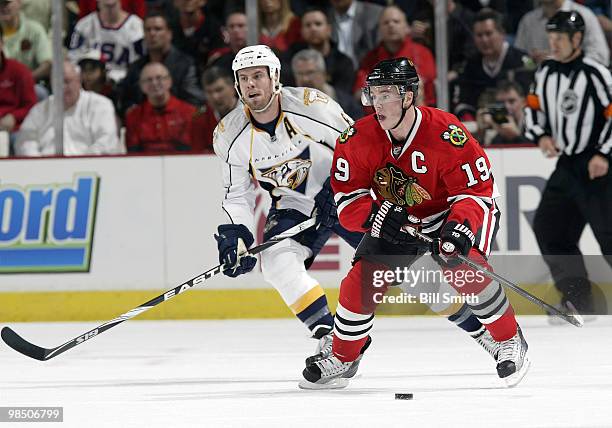 Jonathan Toews of the Chicago Blackhawks approaches the puck as Shea Weber of the Nashville Predators skates behind, at Game One of the Western...