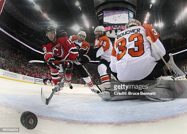 Travis Zajac of the New Jersey Devils watches a shot by Colin White go in the net in the second period against the Philadelphia Flyers in Game Two of...