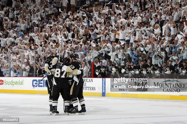 Kris Letang of the Pittsburgh Penguins celebrates his game winning goal with teammates against the Ottawa Senators in Game Two of the Eastern...