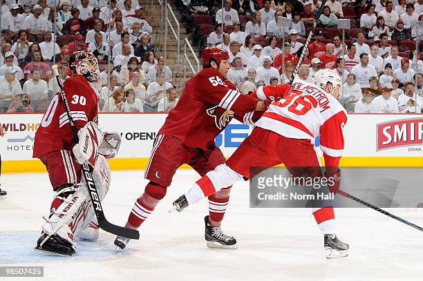 Ed Jovanovski of the Phoenix Coyotes pushes Tomas Holmstrom of the Detroit Red Wings out of the crease in front of goaltender Ilya Bryzgalov in Game...