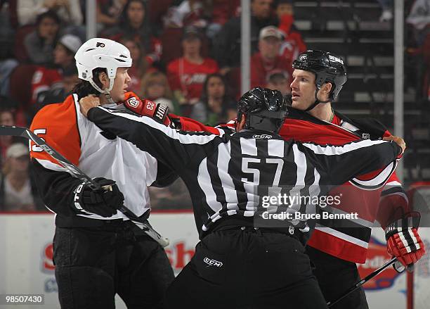 Arron Asham of the Philadelphia Flyers and David Clarkson of the New Jersey Devils are separated by linesman Jay Sharrers in Game Two of the Eastern...