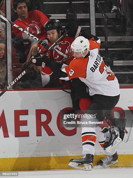 Oskars Bartulis of the Philadelphia Flyers hits David Clarkson of the New Jersey Devils in Game Two of the Eastern Conference Quarterfinals during...