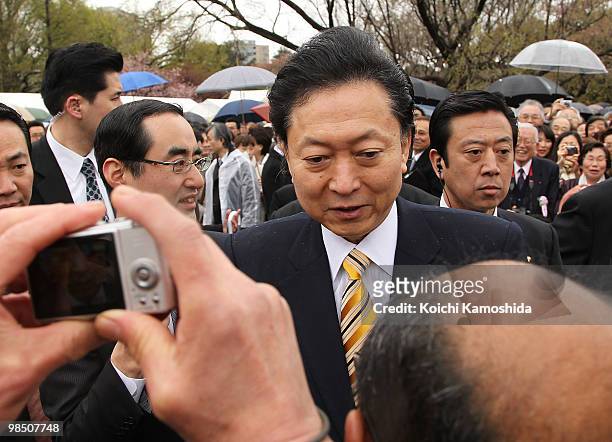 Japanese Prime Minister Yukio Hatoyama greets the crowd during the annual government cherry blossom viewing party at Shinjuku Gyoen park on April 17,...