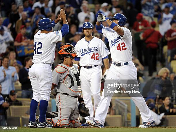 Matt Kemp of the Los Angeles Dodgers celebrates his two run homerun with Rafael Furcal as Andre Ethier and Bengie Molina of the San Francisco Giants...