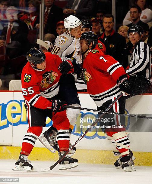 Brent Seabrook of the Chicago Blackhawks collides with Martin Erat of the Nashville Predators as Ben Eager tries to avoid contact in Game One of the...
