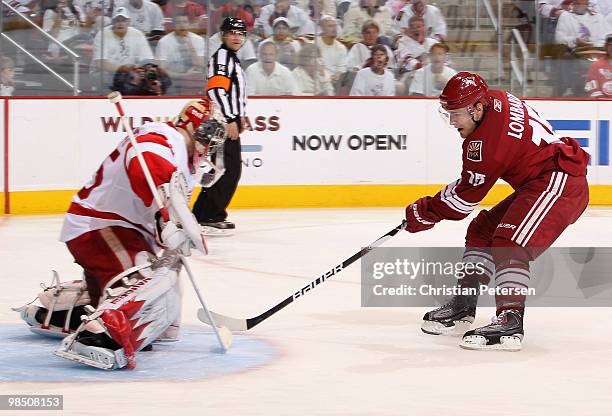 Matthew Lombardi of the Phoenix Coyotes scores a second period goal through the legs of goaltender Jimmy Howard of the Detroit Red Wings in Game Two...