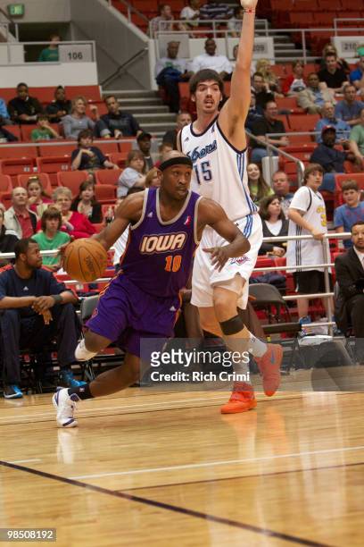 Curtis Stinson of the Iowa Energy drives past Byron Mullens of the Tulsa 66ers in NBA D-League second round playoff action at the Tulsa Convention...