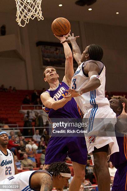 Pat Carroll of the Iowa Energy goes up for a shot with Larry Owens of the Tulsa 66ers defending as the Iowa Energy play the Tulsa 66ers in NBA...