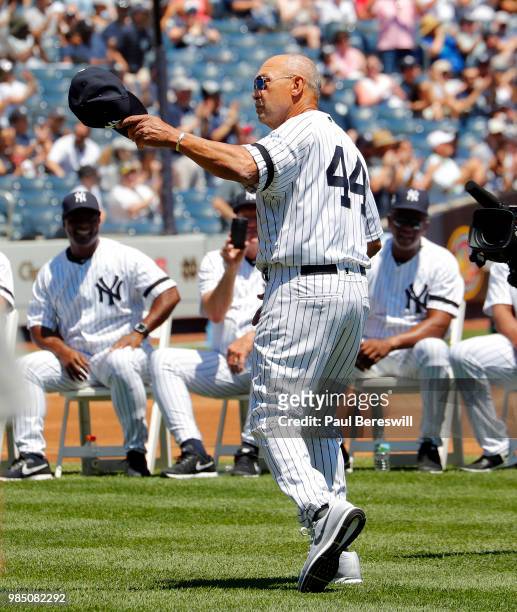 Former Yankees player Reggie Jackson waves to fans as he is introduced on the field at New York Yankees Old Timers Day festivities before an MLB...