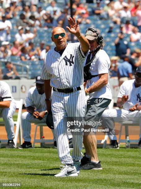 Former Yankees player Reggie Jackson waves to fans as he is introduced on the field at New York Yankees Old Timers Day festivities before an MLB...