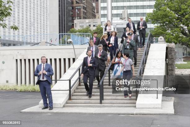 Haakon, Crown Prince of Norway, and Ine Eriksen Soreide, Norwegian Minister of Foreign Affairs, walking with a large group outside the United Nations...