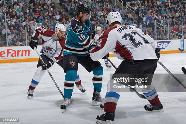 Kyle Quicey of the Colorado Avalanche and Scott Hannan surround Devin Setoguchi of the San Jose Sharks try to retrieve the puck in Game Two of the...