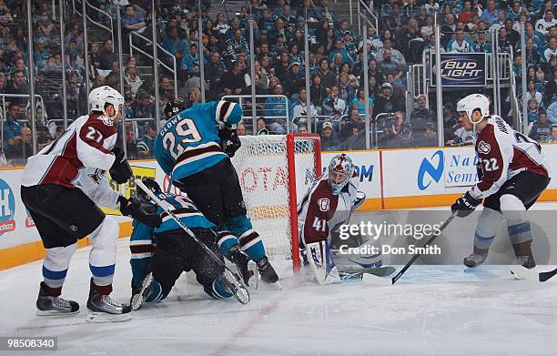 Kyle Quincey, Craig Anderson and Scott Hannan of the Colorado Avalanche search for the puck underneath Devin Setoguchi and Ryane Clowe of the San...