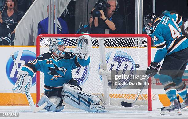 The puck bounces off the chest of Marc-Edouard Vlasic of the San Jose Sharks and past netminder Evgeni Nabokov into the goal in Game Two of the...