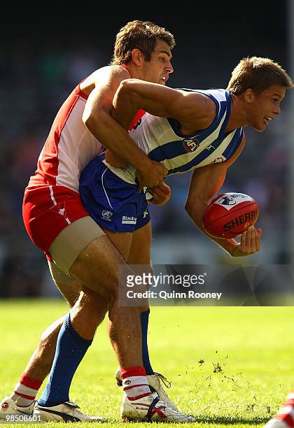 Josh Kennedy of the Swans tackles Andrew Swallow of the Kangaroos during the round four AFL match between the North Melbourne Kangaroos and the...