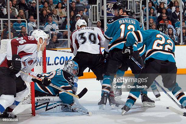 Paul Stastny and TJ Galiardi of the Colorado Avalanche try to find the puck under Evgeni Nabokov, Patrick Marleau and Dan Boyle of the San Jose...