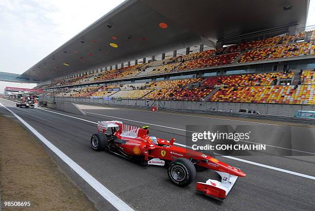 Ferrari driver Fernando Alonso of Spain makes his way out of the pit lane during the third qualifying session for the Formula One Chinese Grand Prix...