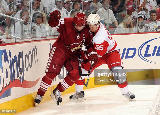 Shane Doan of the Phoenix Coyotes and Niklas Kronwall of the Detroit Red Wings fight for a loose puck along the boards in Game Two of the Western...