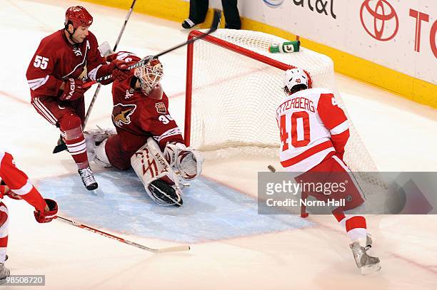 Henrik Zetterberg of the Detroit Red Wings beats Ed Jovanovski and Ilya Bryzgalov of the Phoenix Coyotes and nets the game-winner in Game Two of the...