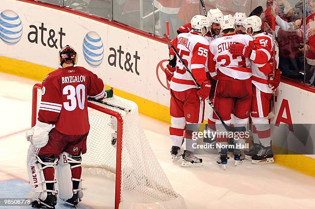 Niklas Kronwall and Brad Stuart of the Detroit Red Wings celebrate with teammates after a goal against Ilya Bryzgalov of the Phoenix Coyotes in Game...