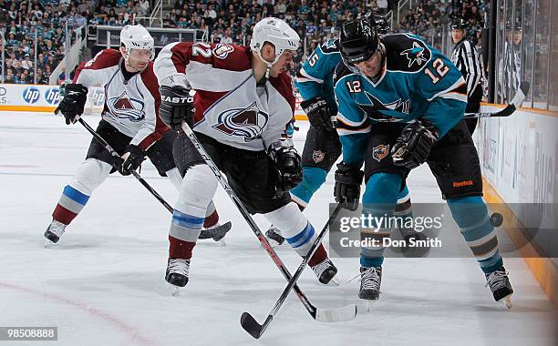 Scott Hannan of the Colorado Avalanche battles for the puck against Patrick Marleau of the San Jose Sharks in Game Two of the Western Conference...