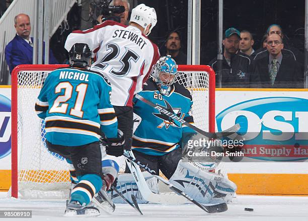 Chris Stewart of the Colorado Avalanche drives to the net past Scott Nichol and toward Evgeni Nabokov of the San Jose Sharks in Game Two of the...