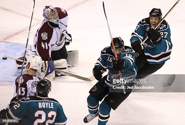 Devin Stoguchi of the San Jose Sharks celebrates with teammate Manny Malhotra after scoring the game winning goal in overtime past goalie Craig...