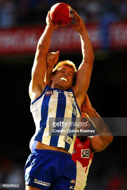 Andrew Swallow of the Kangaroos marks infront of Rhyce Shaw of the Swans during the round four AFL match between the North Melbourne Kangaroos and...