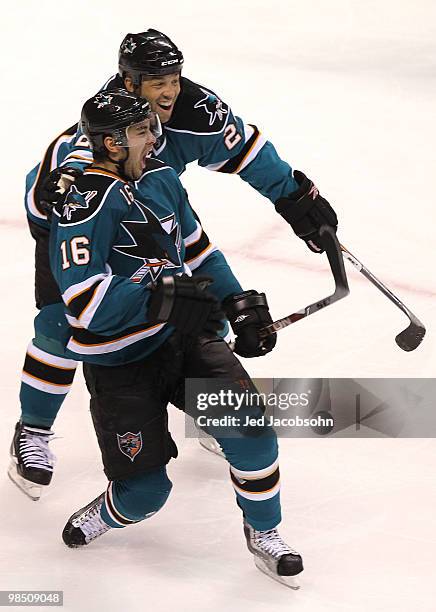 Devin Stoguchi of the San Jose Sharks celebrates with teammate Manny Malhotra after scoring the game winning goal in overtime against the Colorado...