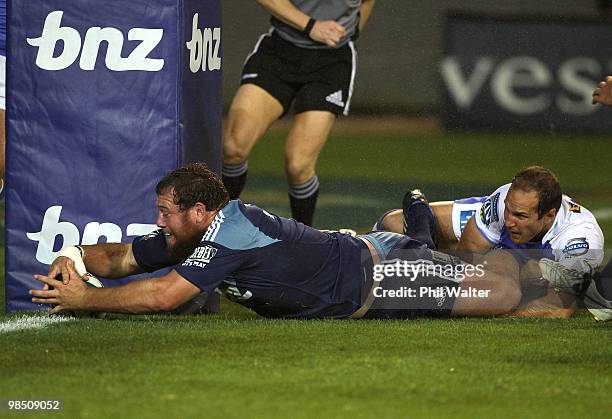 Tony Woodcock of the Blues scores a try in the tackle of Mark Bartholomeuz of the Force during the round 10 Super 14 match between the Blues and the...