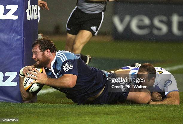 Tony Woodcock of the Blues scores a try in the tackle of Mark Bartholomeuz of the Force during the round 10 Super 14 match between the Blues and the...