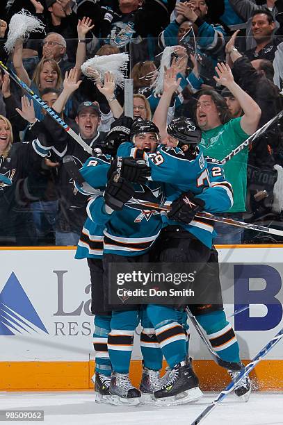 Devin Setoguchi of the San Jose Sharks celebrates his overtime game-winning goal with teammates Joe Pavelski and Ryane Clowe in Game Two of the...