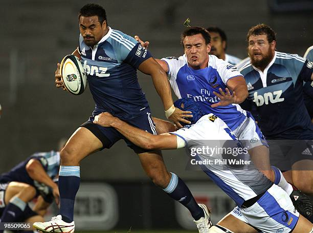 Isaia Toeava of the Blues is tackled by Nathan Sharpe of the Force during the round 10 Super 14 match between the Blues and the Western Force at Eden...